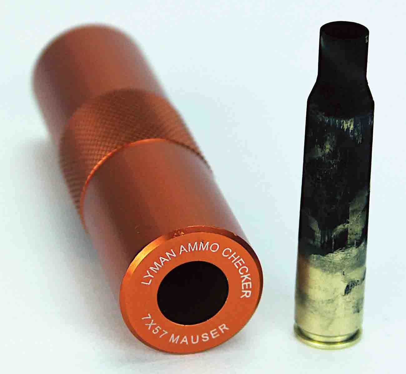 This case was fired with a 60 percent load and neck resized. Shooting it and dropping it in the Lyman Ammo Checker showed the over-expanded case walls caused by the oversize chamber prevent the case from fully entering the gauge (the shoulder hasn’t touched the gauge), yet it still chambers in the military rifle.